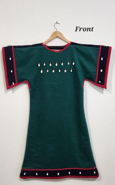 Hand made Native American cowrie shell dress. Main dress material is light wool blend, forest green and navy blue in color with dark red outline. Dress has a muslin inside liner for comfort. Accents consist of silver metal beads, red white ring glass beads, and money top cowrie shells (see images). Accents are sewn with synthetic sinew.  Dress size is US Women's 10-14 Measurements: Bust: 42" Waist: 40" Hips: 42" Length: 34" (armpit to bottom) *For best fit, calculate 2 inches more than your individual measurements. Ribbon Dress Native American, Cowrie Shell Dress, Forest Green And Navy Blue, Shell Dress, Red Outline, Jingle Dress, Native Dress, Native American Regalia, Ribbon Skirts