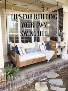 a porch swing bed sitting on top of a stone walkway next to a brick building