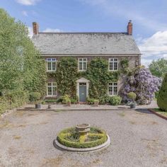 a large house with a fountain in front of it