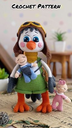 a crochet doll holding a baby doll on top of a table with the words crochet pattern above it