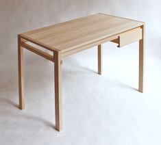 a wooden table sitting on top of a white floor