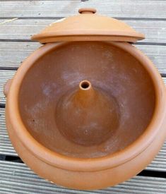 a brown pot sitting on top of a wooden table