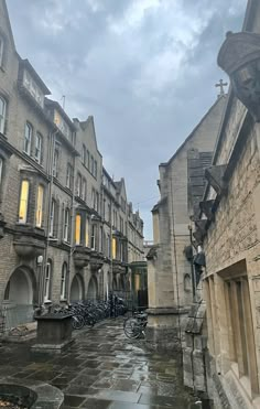 there are many bikes parked on the side of this street in front of some buildings