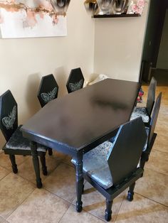 a black table with six chairs around it