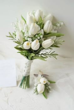 a bouquet of white tulips and other flowers