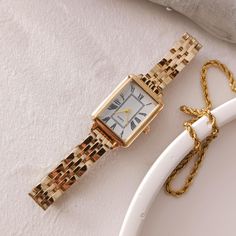 Enhance your elegance with this luxurious gold-plated women's watch featuring a sleek rectangular dial adorned with classic Roman numerals. Perfect for any occasion, this timeless piece combines vintage charm with modern sophistication. The high-quality craftsmanship ensures durability while the adjustable gold link bracelet provides a comfortable fit. Whether as a treat for yourself or a gift for a loved one, this watch is a statement of refined style and grace. Technical specifications: ➡ Move Square Minimalist Watch As A Gift, Minimalist Square Watch As A Gift, Minimalist Square Watch As Gift, Minimalist Square Watches For Gifts, Rectangular Quartz Watch For Everyday Use, Minimalist Rectangular Dial Watch As A Gift, Minimalist Rectangular Dial Watch As Gift, Minimalist Rectangular Dial Watch For Gift, Everyday Rectangular Watches With Metal Dial