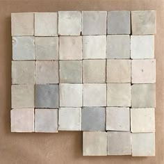 some white and grey tiles on a brown surface