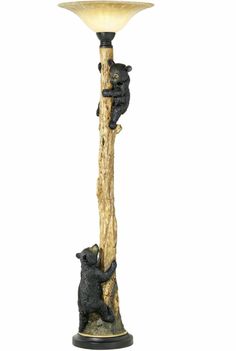 a bear lamp is on top of a wooden pole