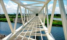 a long white bridge spanning over a river