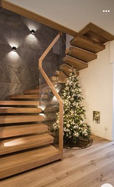 there is a christmas tree next to the stairs