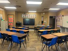 an empty classroom with desks and chairs