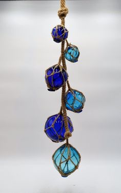 three blue glass hearts hanging from a rope