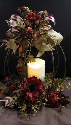 a candle and some flowers on a table