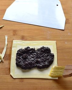 a cookie is being made on top of a piece of paper with a spatula