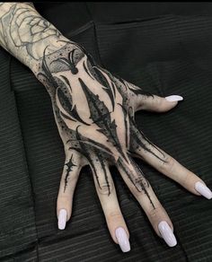 a person's hand with black and white designs on it