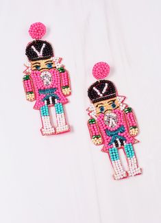 two pairs of pink and black beaded earrings with an image of a nutcracker