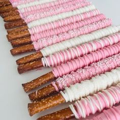 there are many pink and white pretzels lined up