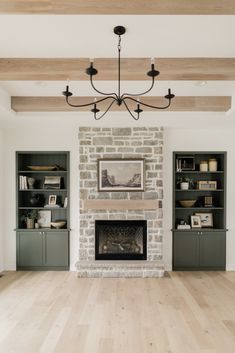 a living room filled with furniture and a fire place in front of a brick fireplace