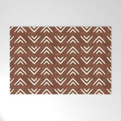 a brown and white area rug with an abstract design