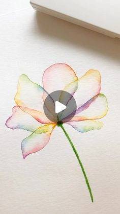 a watercolor painting of a flower on a piece of paper next to a pen