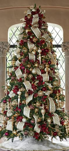 a christmas tree decorated with red and gold ornaments