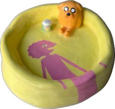 a yellow bathtub with a pink figure in it