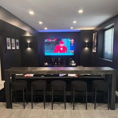 a home theater with chairs and a bar