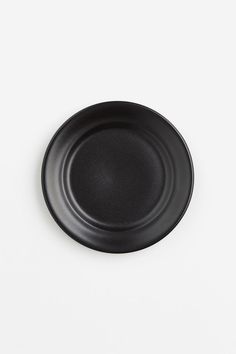 a black plate sitting on top of a white table