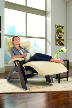 a woman reclining in a chair with her feet up on the table and looking at the camera