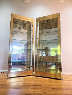 two mirrored doors in the middle of a wooden floor