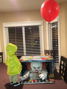 a creepy clown doll in the middle of a table with a balloon attached to it