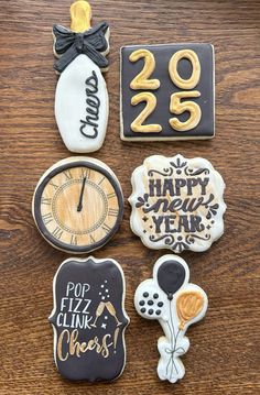 decorated cookies are arranged on a wooden table