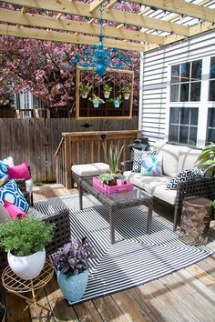 a patio with furniture and plants on it