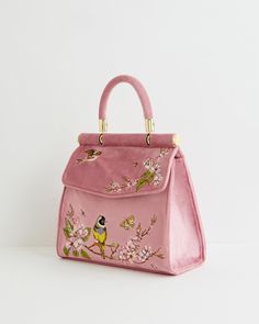 Designed in our hero narrative from our Morning Song collection, our Bird Embroidered Mini tote in powder Pink velvet the ideal carryall to go with any Spring time outfit. Illustrated by nature’s finest blossoming blooms and feathered friends, you’ll find you have a new spring in your step every time you carry it. Whether heading to work or for a special occasion, this tote is spacious enough for all your everyday essentials.  Key Features:   Measurements: Approx. 20cm L x 18cm H x 6cm W   Chain strap  Popper fastening  Clean with damp cloth Cute Things To Buy, Pretty Handbags, Pink Purses, Anthropologie Purse, Fable England, Cool Bags, Spring Time Outfits, Spring Fashion Chic, Cute Purse