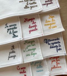 several embroidered napkins with different words on them