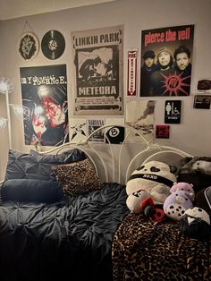 a bedroom with posters on the wall and stuffed animals