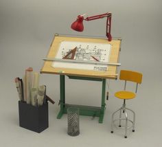 a desk with a drawing board and chair next to it