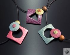 three necklaces with different designs on them