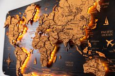 a wooden world map with lights on it