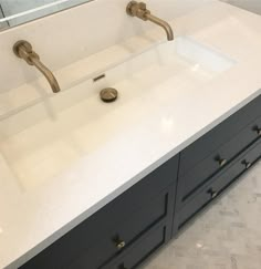 a bathroom sink with two faucets on the top and one in the middle