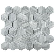 a white marble mosaic tile with grey hexagonal tiles on the bottom and sides