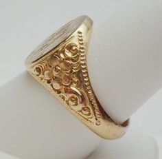 This is a really pretty signet ring from the Art Nouveau period. The ring has an oval signet area that measures 16 x 14 mm. The signet is already hand engraved with a monogram. The sides of the ring has a lovely carved floral design with a beaded edge. This ring is a nice size for either a man or a woman. The ring is stamped 14K and weighs 12.0 grams. The ring is engraved inside M B to P F. The ring is a size 10. *Sizing is available. Please message us for a quote* *We are always willing to ship Luxury Antique Signet Ring With Single Cut Diamonds, Luxury Antique Engraved Filigree Ring, Luxury Traditional Carved Rings, Luxury Vintage Signet Ring With Hallmarks, Luxury Antique Signet Ring Stamped 925, Luxury Vintage Signet Ring With Engraving Option, Luxury Vintage Signet Ring With Polished Finish, Luxury Victorian Engraved Yellow Gold Ring, Luxury Silver Art Deco Signet Ring