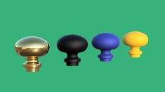 four different colored knobs on a green background