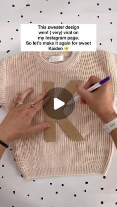 a person cutting out a paper bow on top of a t - shirt that says, this sweater design is my instagram page so it's made again for sweet