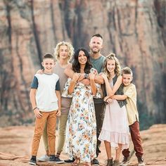 a family poses for a photo in front of the grand canyon