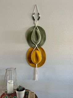 a table topped with plates and a vase filled with flowers next to a wall mounted clock