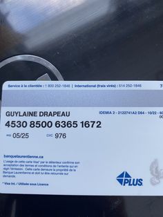 a close up of a business card attached to a vehicle's door handle with the name guyliane drapeau on it