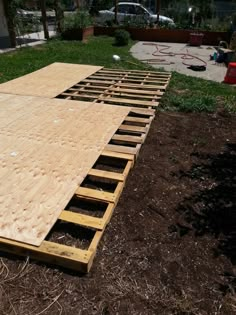 an unfinished wooden floor in the middle of a yard