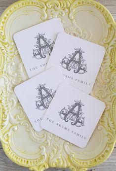 four personalized coasters on a yellow plate