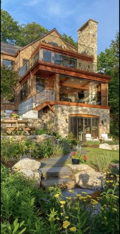 a large stone house surrounded by greenery and trees